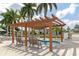 View of the community hot tub with seating and a pergola, surrounded by palm trees at 3352 Laurel Oak Way, Sarasota, FL 34237
