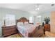 Comfortable bedroom with hardwood floors, ceiling fan and light green walls at 3352 Laurel Oak Way, Sarasota, FL 34237