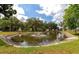 Scenic pond with a fountain surrounded by mature trees and well-maintained landscaping at 3352 Laurel Oak Way, Sarasota, FL 34237