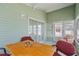 Bright sun room with vaulted ceiling, large windows and a small table and chairs at 3352 Laurel Oak Way, Sarasota, FL 34237