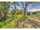 Lush backyard featuring mature trees and a tranquil stream at 3500 Green View Ct # 45, Sarasota, FL 34231