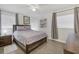 Comfortable bedroom featuring two windows, wood floors, and soft, neutral bedding at 3500 Green View Ct # 45, Sarasota, FL 34231