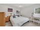 Bright bedroom featuring a ceiling fan, tile floors, and a wooden dresser at 3500 Green View Ct # 45, Sarasota, FL 34231