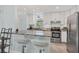 Bright kitchen featuring white cabinets, gray countertops, and stainless steel appliances at 3500 Green View Ct # 45, Sarasota, FL 34231