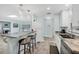 Bright kitchen with granite countertops, stainless steel appliances, and a breakfast bar with modern pendant lights at 3500 Green View Ct # 45, Sarasota, FL 34231