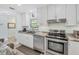 Updated kitchen with stainless appliances, grey countertops, and white cabinetry at 3500 Green View Ct # 45, Sarasota, FL 34231