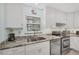 Well-lit kitchen featuring white cabinets, granite countertops, and stainless steel appliances for a modern look at 3500 Green View Ct # 45, Sarasota, FL 34231