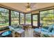 Charming sunroom with large windows, tropical-patterned furniture, and plenty of natural light at 3500 Green View Ct # 45, Sarasota, FL 34231