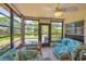Bright sunroom with expansive windows, offering beautiful views of the outdoors and comfortable seating at 3500 Green View Ct # 45, Sarasota, FL 34231