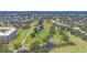 Expansive aerial view of golf course community featuring water hazards, trees, and condo buildings at 3750 Pinebrook Cir # 405, Bradenton, FL 34209