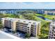 Aerial view of the condo building with golf course and water views at 3750 Pinebrook Cir # 405, Bradenton, FL 34209