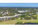 Panoramic aerial view showing the condominium and surrounding golf course with water and landscaping at 3750 Pinebrook Cir # 405, Bradenton, FL 34209