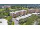 Aerial view of the condo building with golf course views, mature trees, and covered parking at 3750 Pinebrook Cir # 405, Bradenton, FL 34209