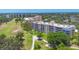 Beautiful aerial view of community buildings by golf course, featuring ponds and mature landscaping at 3750 Pinebrook Cir # 405, Bradenton, FL 34209