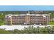 Aerial view of the condo building with mature trees and covered parking at 3750 Pinebrook Cir # 405, Bradenton, FL 34209