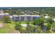 Stunning aerial image of condos overlooking golf course with trees and water features at 3750 Pinebrook Cir # 405, Bradenton, FL 34209