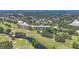 Elevated aerial shot capturing condo buildings, manicured grounds, and surrounding golf course landscape at 3750 Pinebrook Cir # 405, Bradenton, FL 34209
