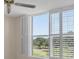 Bedroom features a large window with stylish shutters overlooking the community golf course at 3750 Pinebrook Cir # 405, Bradenton, FL 34209