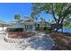 Exterior view of the community clubhouse with lush landscaping and lake view at 3750 Pinebrook Cir # 405, Bradenton, FL 34209