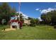 Exterior view of the community clubhouse and well-maintained landscaping at 3750 Pinebrook Cir # 405, Bradenton, FL 34209