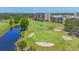 Scenic golf course showcasing manicured greens, sand traps, and nearby condo buildings at 3750 Pinebrook Cir # 405, Bradenton, FL 34209