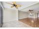 Bright living room featuring tile and wood flooring, ceiling fans, and open access to the kitchen area at 3750 Pinebrook Cir # 405, Bradenton, FL 34209