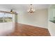 Bright living room features hardwood floors, ceiling fans, and a chandelier at 3750 Pinebrook Cir # 405, Bradenton, FL 34209