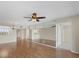 Open-concept living area with hardwood floors, mirrored walls, and seamless kitchen access at 3750 Pinebrook Cir # 405, Bradenton, FL 34209