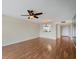 Inviting living area with hardwood floors, stylish ceiling fan, and seamless kitchen access at 3750 Pinebrook Cir # 405, Bradenton, FL 34209