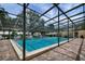 A clear view of an enclosed pool with brick-laid surround and several lounge chairs at 3750 Pinebrook Cir # 405, Bradenton, FL 34209