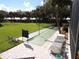 View of the shuffleboard court with shade canopy nearby and building in background at 3750 Pinebrook Cir # 405, Bradenton, FL 34209