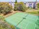 Well-maintained tennis courts surrounded by trees with a view of condos in the background at 3750 Pinebrook Cir # 405, Bradenton, FL 34209