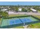 Well-maintained tennis courts with a new looking surface with nearby residential neighborhood in view at 3750 Pinebrook Cir # 405, Bradenton, FL 34209