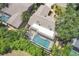 Backyard aerial view of swimming pool inside of a screen enclosure, with a privacy fence at 4079 Woodview Dr, Sarasota, FL 34232