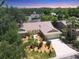 An aerial perspective of a well maintained home surrounded by lush greenery and mature trees at 4079 Woodview Dr, Sarasota, FL 34232