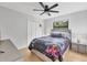 Bedroom features updated ceiling fan and brightly colored bedding at 4079 Woodview Dr, Sarasota, FL 34232