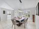 Dining room featuring a modern light fixture, shuttered window, and access to the kitchen at 4079 Woodview Dr, Sarasota, FL 34232