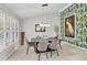 Elegant dining room featuring modern decor and ample natural light from the window at 4079 Woodview Dr, Sarasota, FL 34232