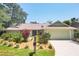 Lovely one-story home with a well-maintained lawn and colorful tropical plants at 4079 Woodview Dr, Sarasota, FL 34232