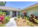 Charming home with beautifully landscaped front yard, featuring tropical plants and a welcoming entrance at 4079 Woodview Dr, Sarasota, FL 34232