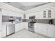 Bright kitchen with stainless steel appliances, tiled backsplash, and ample countertop space at 4079 Woodview Dr, Sarasota, FL 34232