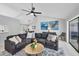 Cozy living room featuring a ceiling fan, modern decor, and access to the outside at 4079 Woodview Dr, Sarasota, FL 34232
