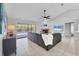Bright living room features a cozy fireplace, vaulted ceiling, and access to the screened-in pool area at 4079 Woodview Dr, Sarasota, FL 34232