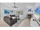 Comfortable living room featuring a fireplace, ceiling fan, and access to the pool area at 4079 Woodview Dr, Sarasota, FL 34232