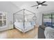Serene main bedroom with a four poster bed, modern decor, and sliding glass doors at 4079 Woodview Dr, Sarasota, FL 34232