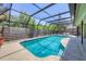 Enclosed swimming pool with a screened in enclosure and a surrounding privacy fence at 4079 Woodview Dr, Sarasota, FL 34232