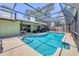 Enclosed swimming pool with ladder, backyard view of the home and outdoor seating area at 4079 Woodview Dr, Sarasota, FL 34232