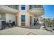 Spacious covered balcony with sitting areas, beautiful tile, and panoramic bay view at 420 Golden Gate Pt # 200A, Sarasota, FL 34236