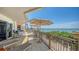 Expansive outdoor balcony with water views, built-in grill, and multiple seating areas for entertaining at 420 Golden Gate Pt # 200A, Sarasota, FL 34236