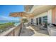 Spacious balcony featuring sun umbrellas, an outdoor kitchen and gorgeous views at 420 Golden Gate Pt # 200A, Sarasota, FL 34236